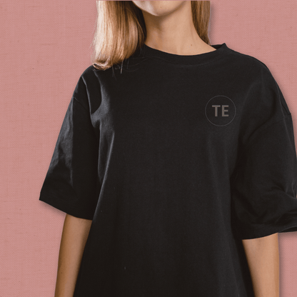 Black custom t-shirt with subtle 'TE' logo on chest, part of Secure Tee Deposit for quick mockup and 48hr design proof service.